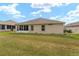 A view of the backyard, which features a screened in porch at 9175 Se 118Th Loop, Summerfield, FL 34491