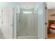 Bathroom features glass-enclosed shower with framed glass door at 9175 Se 118Th Loop, Summerfield, FL 34491