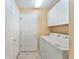 Neat laundry room with tile flooring, storage cabinets, and included washer and dryer at 9175 Se 118Th Loop, Summerfield, FL 34491