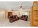 Open concept living room with tile floors and two leather sofas at 9175 Se 118Th Loop, Summerfield, FL 34491