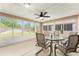 Enclosed patio area perfect for entertaining featuring ceiling fan and outdoor furniture at 9175 Se 118Th Loop, Summerfield, FL 34491