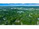Expansive aerial view showcasing the property's lush green surroundings and neighborhood at 942 Ne 5Th St, Ocala, FL 34470