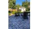 Picturesque backyard featuring a stone-paved patio with comfortable seating and a fire pit centerpiece at 942 Ne 5Th St, Ocala, FL 34470