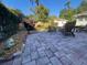 Charming backyard with brick pavers, lush landscaping, and comfortable seating, ideal for outdoor living at 942 Ne 5Th St, Ocala, FL 34470