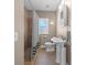 Cozy bathroom featuring a tiled shower, pedestal sink, and vintage-style fixtures at 942 Ne 5Th St, Ocala, FL 34470