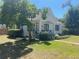 Charming home featuring well-manicured lawn, mature trees, and classic architectural design at 942 Ne 5Th St, Ocala, FL 34470