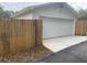 Detached two car garage with white siding and a concrete driveway, offering convenient parking at 942 Ne 5Th St, Ocala, FL 34470