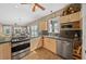Open concept kitchen features stainless steel appliances and a gas range at 942 Ne 5Th St, Ocala, FL 34470