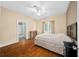 Bright main bedroom boasts hardwood floors, a ceiling fan, and a neutral color scheme at 942 Ne 5Th St, Ocala, FL 34470