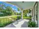 Inviting porch view showcasing black iron railings and a peaceful neighborhood scene at 942 Ne 5Th St, Ocala, FL 34470