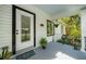 Cozy front porch featuring a decorative rug and hanging plants, perfect for relaxing at 942 Ne 5Th St, Ocala, FL 34470