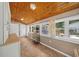 Bright sunroom with wood ceiling, numerous windows, and stylish decor at 942 Ne 5Th St, Ocala, FL 34470