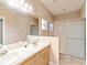 Bathroom features double sinks with sliding glass door shower and tiled floor at 9525 Sw 53Rd Cir, Ocala, FL 34476