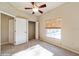 Cozy bedroom features a ceiling fan, plush carpeting, and a window providing natural light at 9525 Sw 53Rd Cir, Ocala, FL 34476