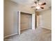 Cozy bedroom with soft carpet, ceiling fan, and a spacious walk-in closet at 9525 Sw 53Rd Cir, Ocala, FL 34476
