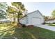 A well-maintained home with a white exterior, an attached garage, and a neatly manicured lawn at 9525 Sw 53Rd Cir, Ocala, FL 34476