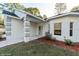Inviting front entrance with covered porch, grey accent decor, and manicured landscaping at 9525 Sw 53Rd Cir, Ocala, FL 34476