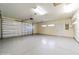 Spacious two car garage features a large door and ample ceiling lighting at 9525 Sw 53Rd Cir, Ocala, FL 34476