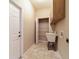 Functional laundry room features a utility sink and a built-in storage rack above at 9525 Sw 53Rd Cir, Ocala, FL 34476