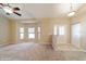 Open living room with neutral carpet, vaulted ceilings, bay window, and glass door at 9525 Sw 53Rd Cir, Ocala, FL 34476