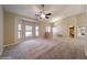 Open living room with neutral carpet, vaulted ceilings, bay window, and a ceiling fan at 9525 Sw 53Rd Cir, Ocala, FL 34476
