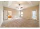 Spacious main bedroom boasts tray ceilings, plush carpets, and ensuite bathroom access at 9525 Sw 53Rd Cir, Ocala, FL 34476