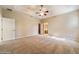 Large main bedroom featuring tray ceilings, plush carpets, and ensuite bathroom access at 9525 Sw 53Rd Cir, Ocala, FL 34476