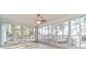 Bright sunroom with tile floors and many windows overlooking the fenced backyard at 9525 Sw 53Rd Cir, Ocala, FL 34476