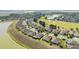 An aerial view shows manicured lawns surrounding a quiet residential neighborhood next to a golf course at 9532 Sw 70Th Loop, Ocala, FL 34481