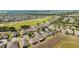 An aerial view of a residential neighborhood next to a golf course on a sunny day at 9532 Sw 70Th Loop, Ocala, FL 34481