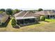 The home's backyard offers a screened-in lanai and is beautifully landscaped, creating a peaceful retreat at 9532 Sw 70Th Loop, Ocala, FL 34481