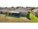Aerial view of backyard features a screened lanai and lush landscaping, enhancing the outdoor living experience at 9532 Sw 70Th Loop, Ocala, FL 34481