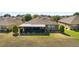 Aerial view of the backyard features a screened lanai and lush landscaping, perfect for outdoor enjoyment and relaxation at 9532 Sw 70Th Loop, Ocala, FL 34481