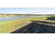View of a peaceful backyard overlooking a tranquil pond with fountains, providing a serene and picturesque outdoor space at 9532 Sw 70Th Loop, Ocala, FL 34481