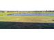 Scenic backyard view overlooking a tranquil pond with a fountain and lush green space at 9532 Sw 70Th Loop, Ocala, FL 34481