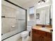 Bright bathroom with a decorative tiled shower over tub and granite vanity at 9532 Sw 70Th Loop, Ocala, FL 34481