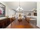 Spacious dining area with elegant chandelier, and open view to kitchen and living spaces at 9532 Sw 70Th Loop, Ocala, FL 34481