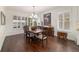 Dining room with wood floors, plantation shutters, and wooden table perfect for entertaining at 9532 Sw 70Th Loop, Ocala, FL 34481