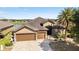 Stunning home with a three-car garage, paver driveway, lush landscaping, and a beautiful lake view at 9532 Sw 70Th Loop, Ocala, FL 34481