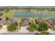 Beautiful single-story home with a well-manicured front yard, a brick driveway, and a lake view at 9532 Sw 70Th Loop, Ocala, FL 34481