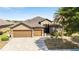 Charming home featuring a brick paved driveway, a three-car garage, and mature landscaping at 9532 Sw 70Th Loop, Ocala, FL 34481