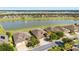 Scenic aerial view of single-Gathering homes located next to a large pond with a fountain feature at 9532 Sw 70Th Loop, Ocala, FL 34481