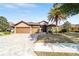 Inviting home boasts a three-car garage, paver driveway, well-maintained landscaping, and charming curb appeal at 9532 Sw 70Th Loop, Ocala, FL 34481