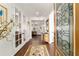 Bright foyer with hardwood floors, decorative rug, and views into the living spaces at 9532 Sw 70Th Loop, Ocala, FL 34481