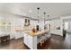 Spacious kitchen featuring a large center island, pendant lighting, and modern white cabinetry at 9532 Sw 70Th Loop, Ocala, FL 34481