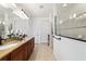 Main bathroom features double sinks, granite countertops, and a tiled walk-in shower at 9532 Sw 70Th Loop, Ocala, FL 34481