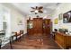 Home office with hardwood floors, built-in shelving, and a ceiling fan at 9532 Sw 70Th Loop, Ocala, FL 34481