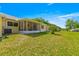 Spacious backyard featuring a screened porch and lush green grass, great for outdoor activities at 9638 Sw 94Th Ave # C, Ocala, FL 34481