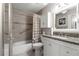Well-lit bathroom featuring a shower-tub combo and granite countertop vanity with white cabinets at 9638 Sw 94Th Ave # C, Ocala, FL 34481