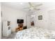 Bedroom featuring ceiling fan and view into a dining room at 9638 Sw 94Th Ave # C, Ocala, FL 34481